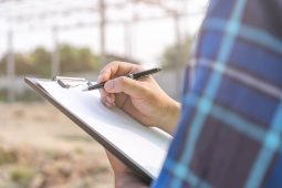 Site supervisor checking list items while on site