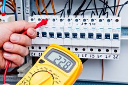 Electrician checking the power levels in a breaker