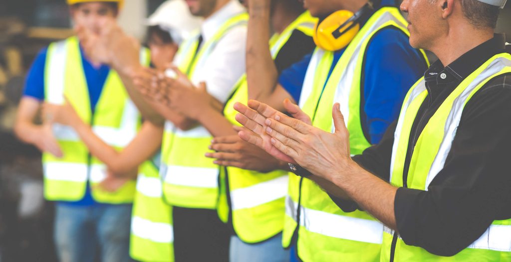 Construction workers clapping